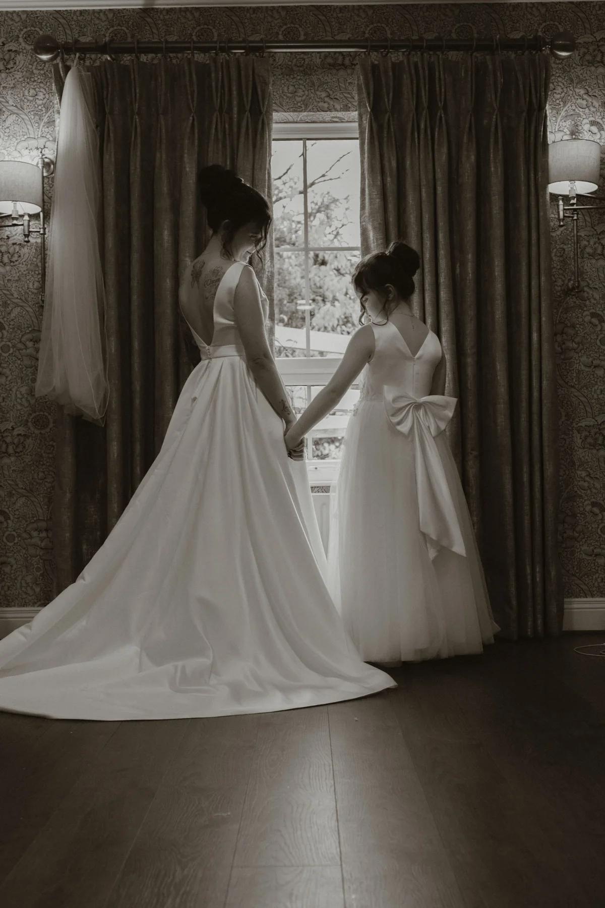 A tender wedding moment by the window