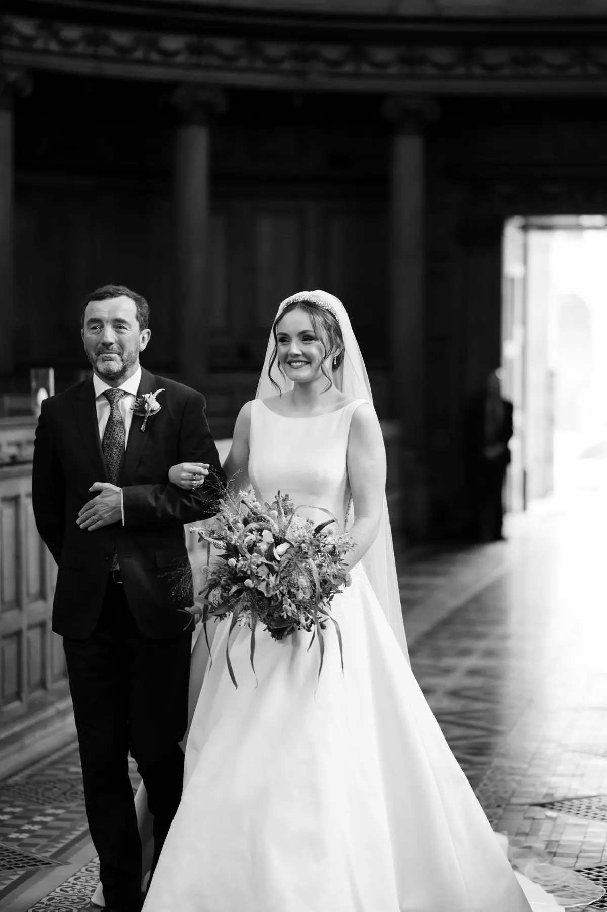 Carole and Stephen framed by the chapel doorway in black and white