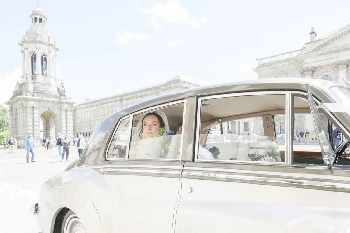 Carole arriving in the wedding car with the Campanile behind