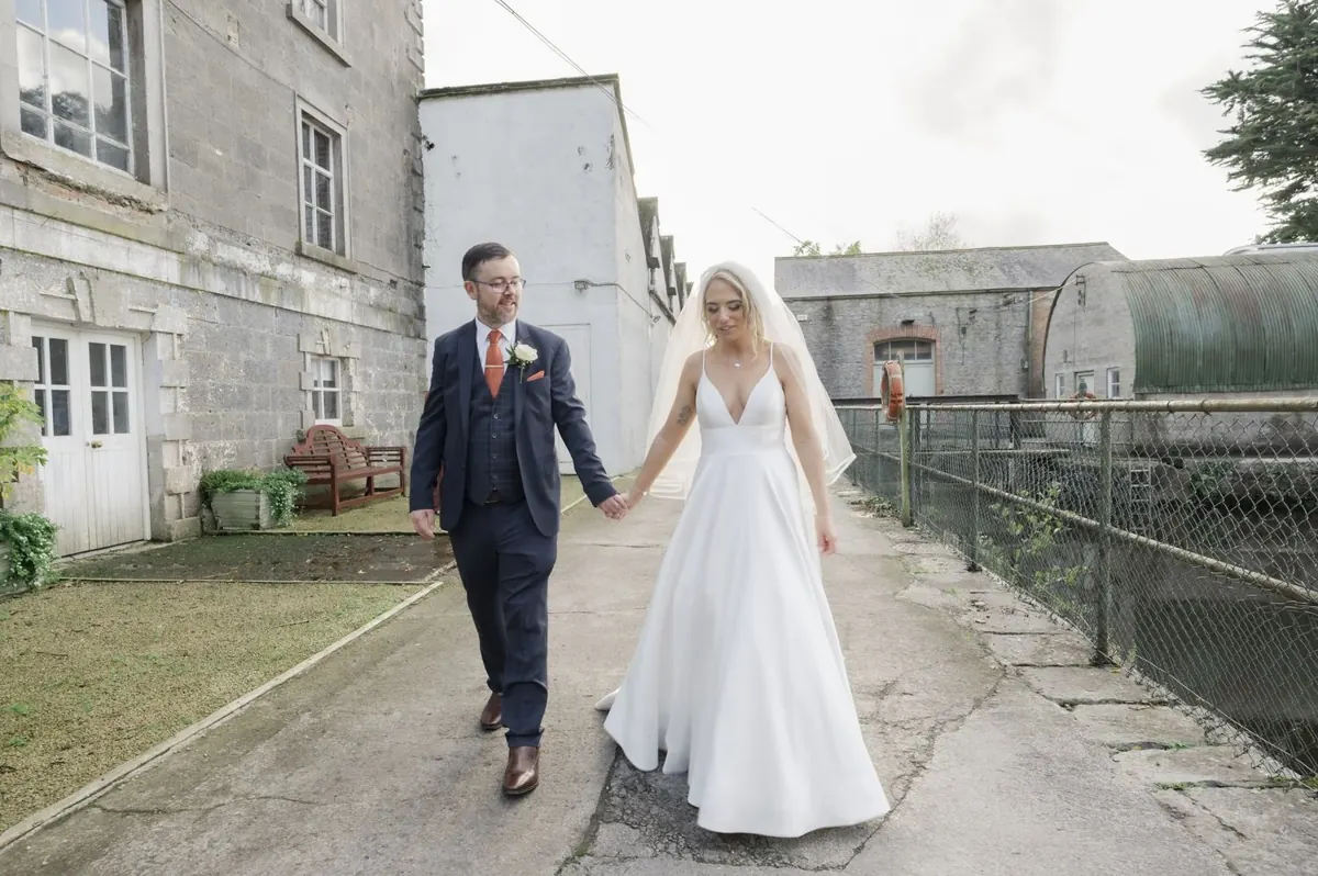 Charlie and Steven walking beside the stone buildings