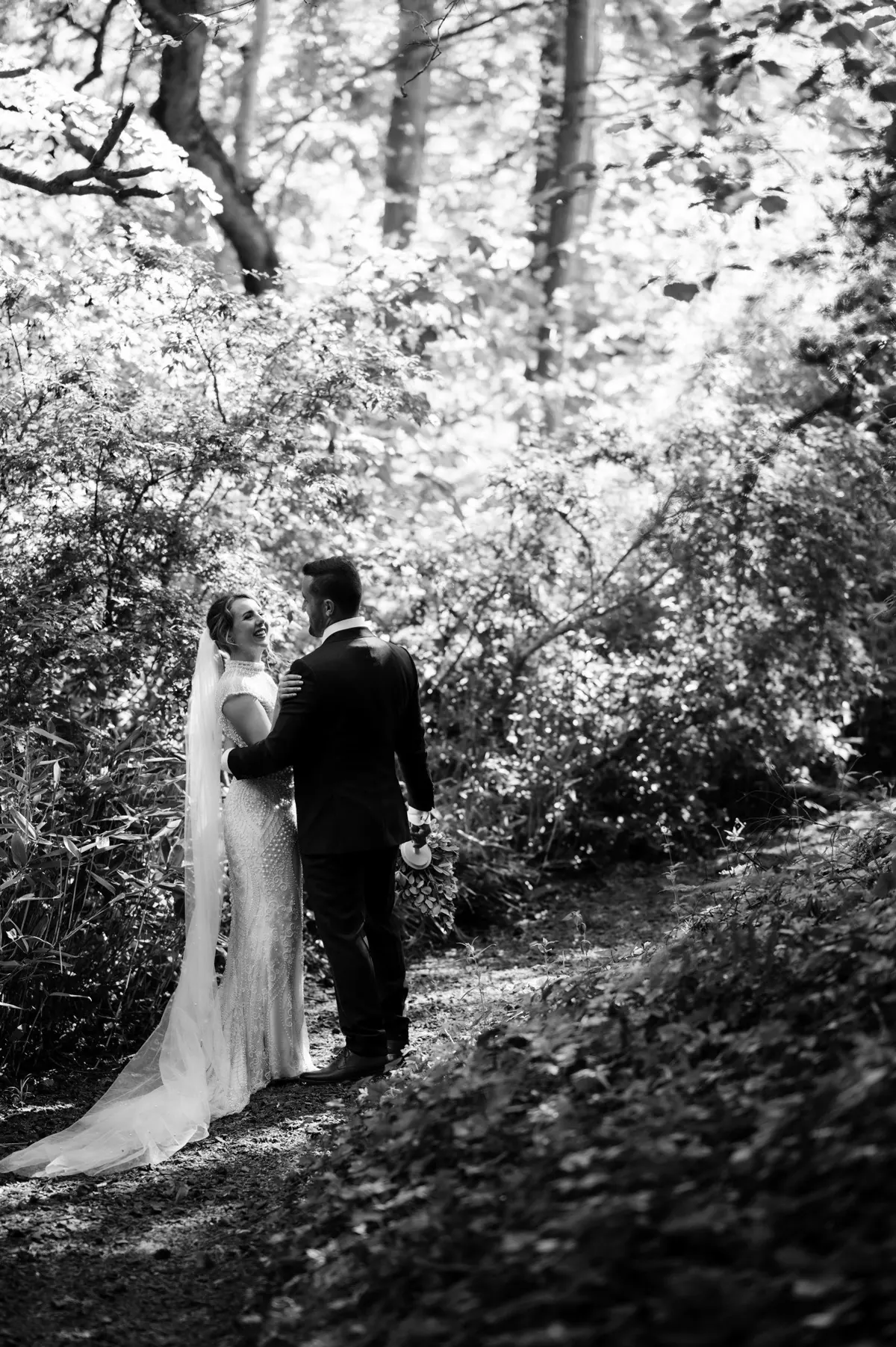 Steph and Ramon beneath the trees in black and white