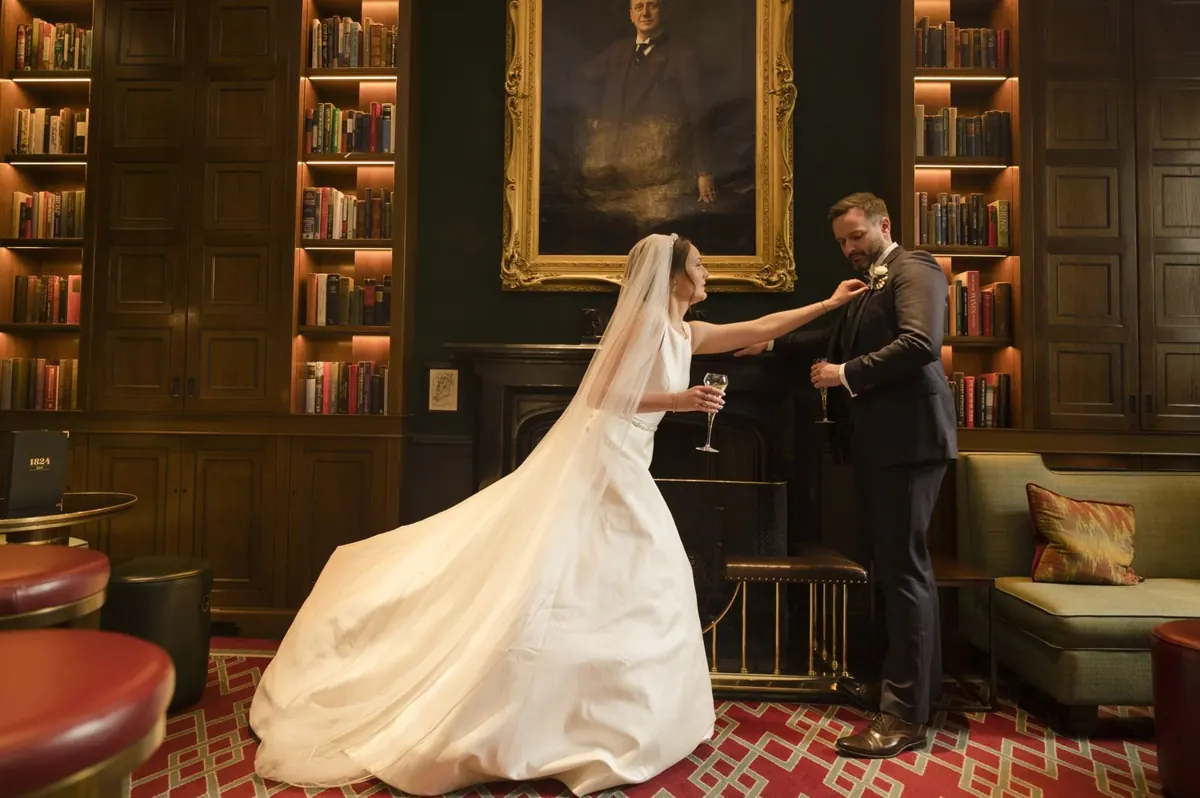 Carole and Stephen making a portrait in a book-lined hotel interior.
