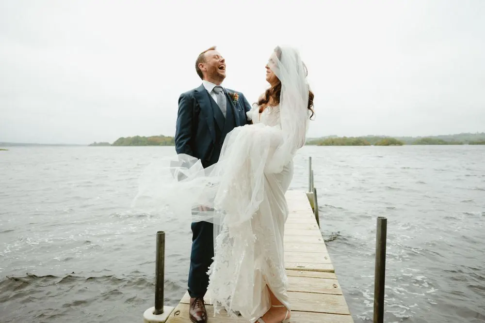 Aine and John laughing together beside the lake at Virginia Park Lodge.