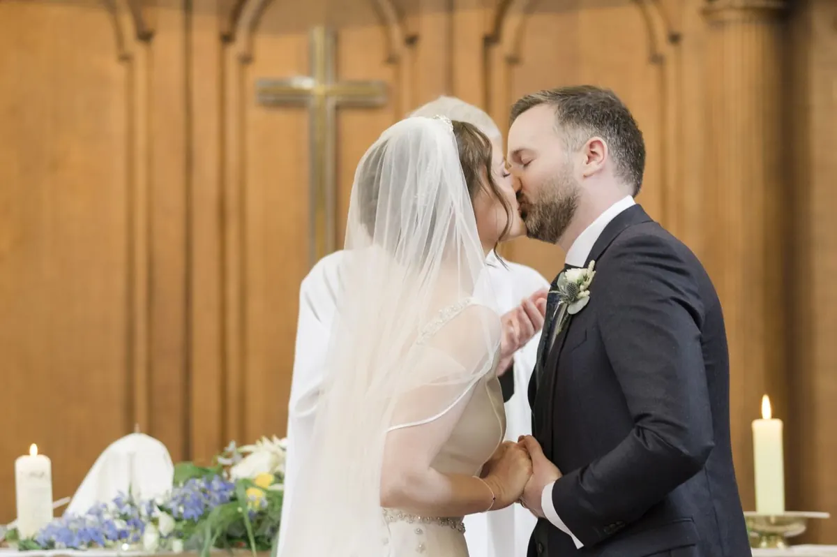 Carole and Stephen sharing a kiss during the chapel ceremony