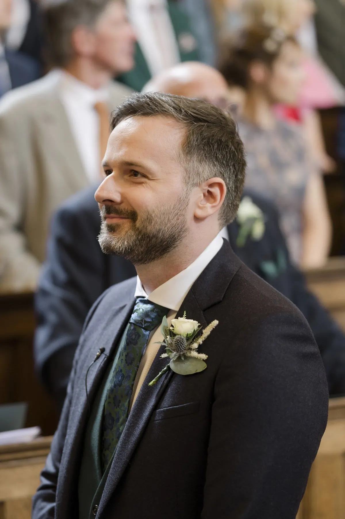 Stephen seated with the ceremony guests behind him