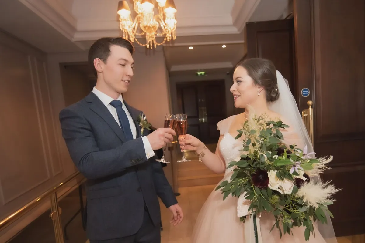The couple sharing a toast inside The Westbury