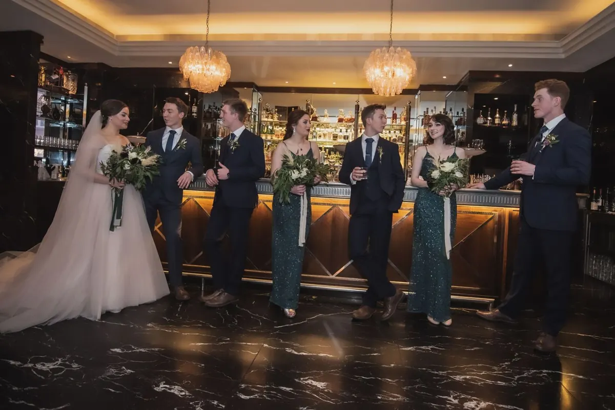 The couple with guests at the hotel bar