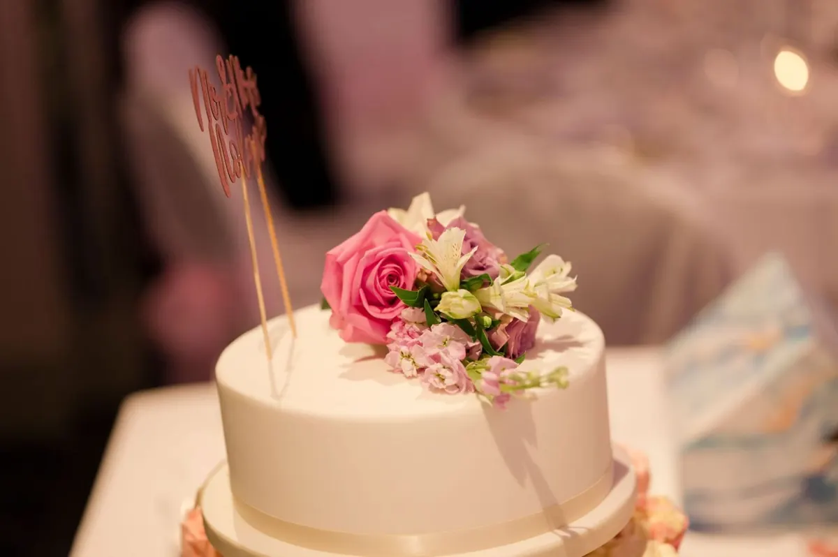 Michelle and Chris’s wedding cake with pink flowers.