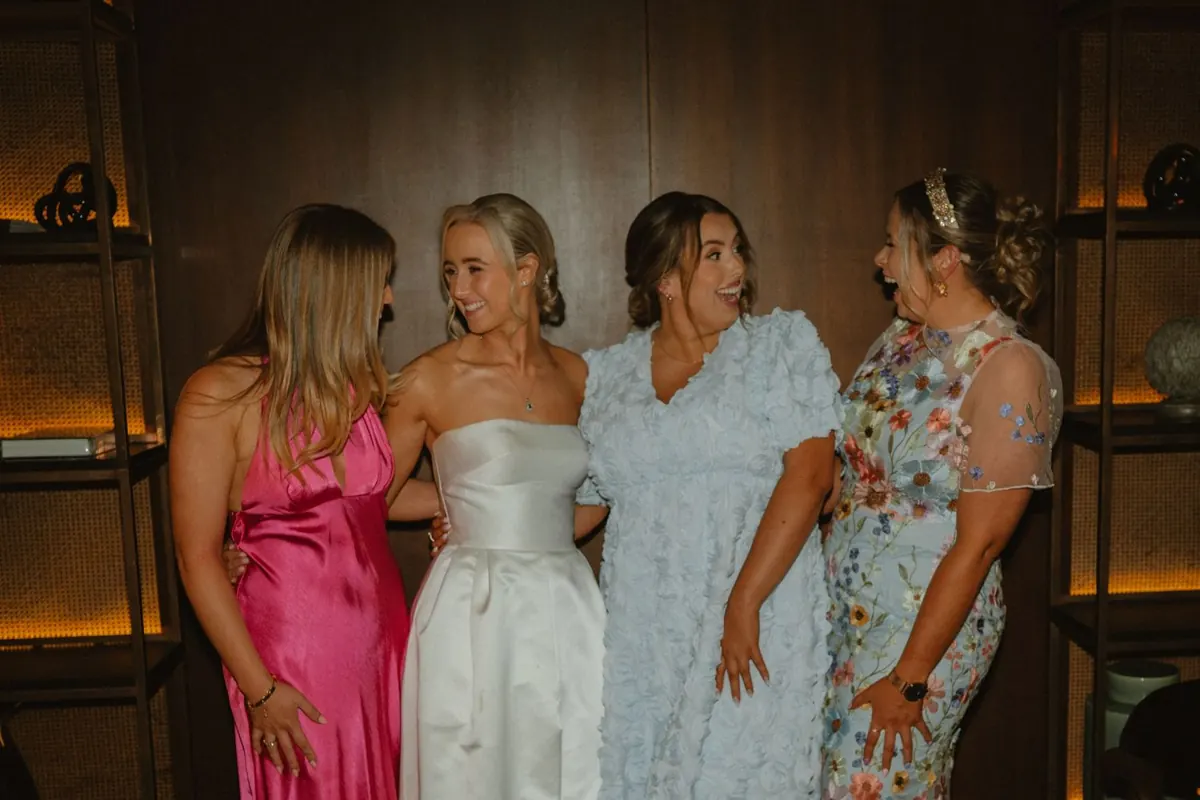 The bride posing with guests during the reception