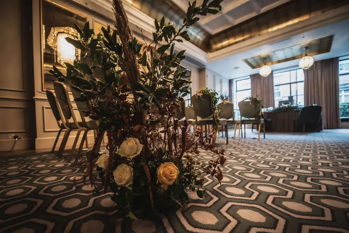 Flowers and chairs arranged for the indoor ceremony
