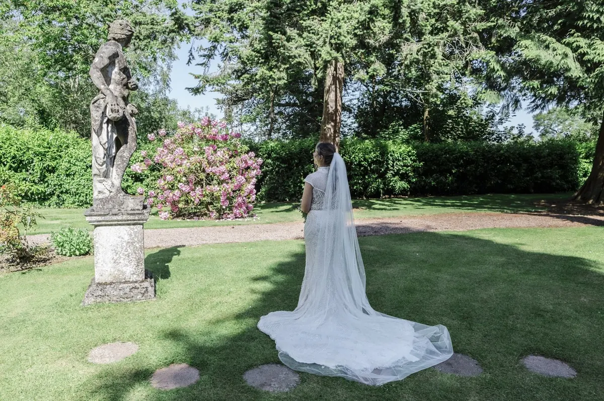 Steph’s dress train spread across the lawn in the estate gardens