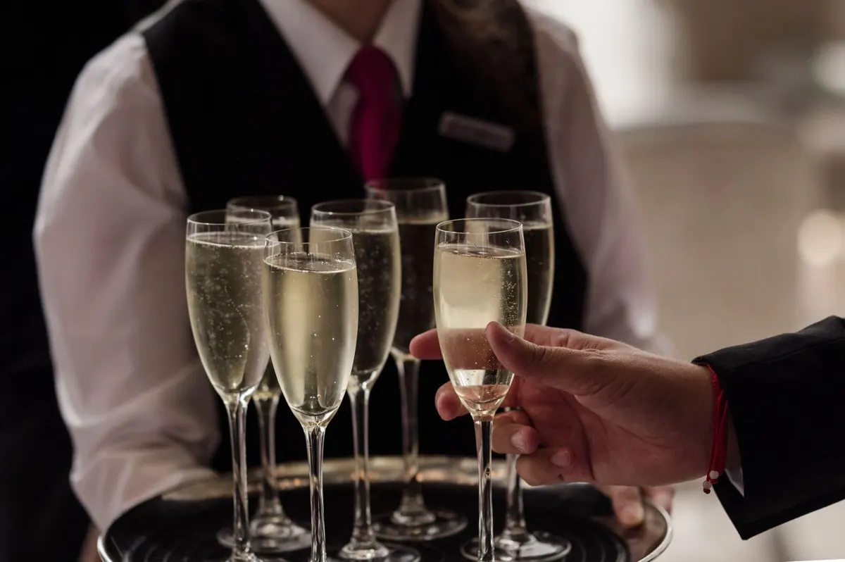 Champagne glasses being served at the reception.
