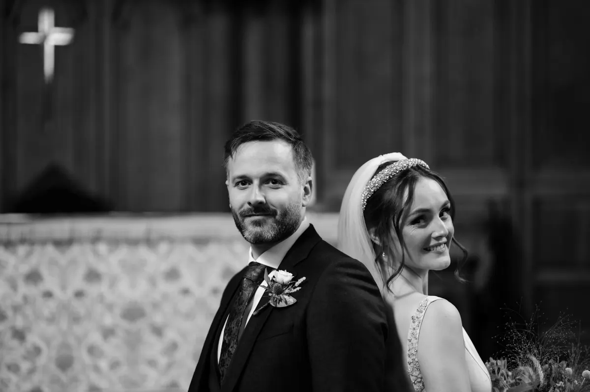 The couple together against the dark chapel interior