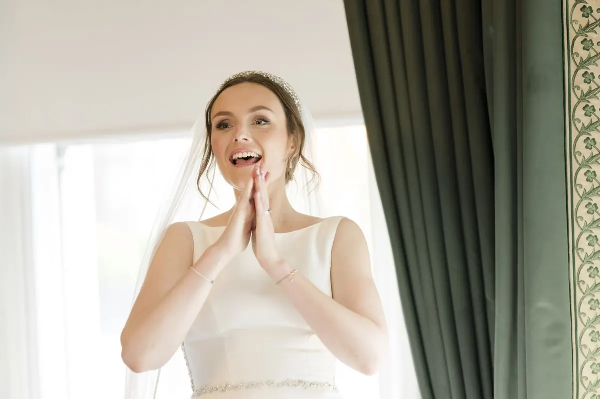 Carole laughing beside the window.