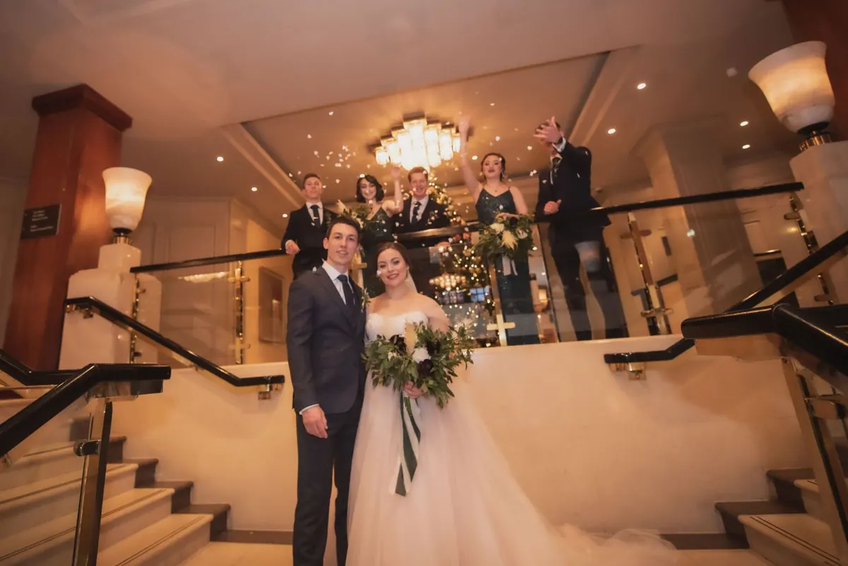 The couple together on the staircase at The Westbury