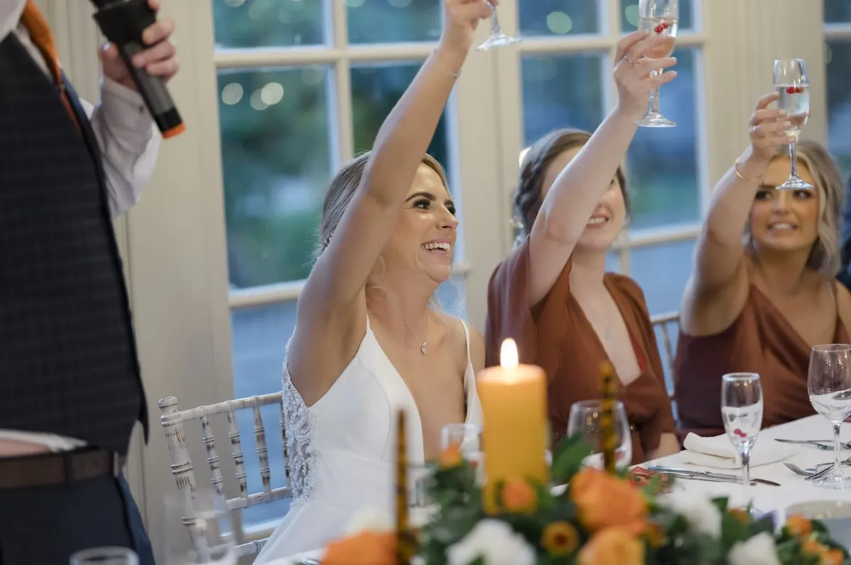 Glasses raised around the top table