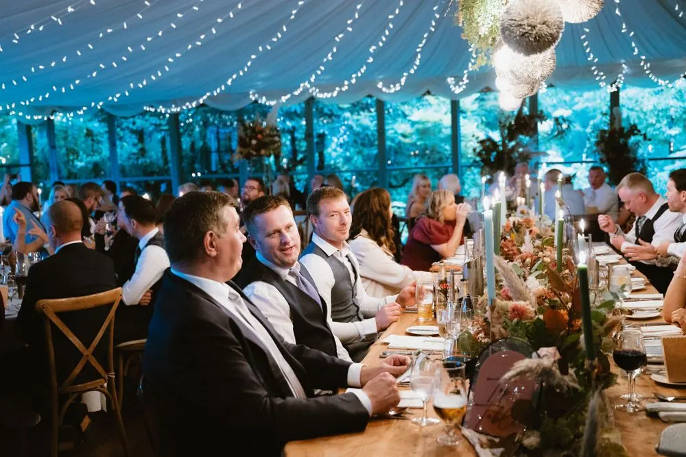 Guests gathered around the long reception tables.