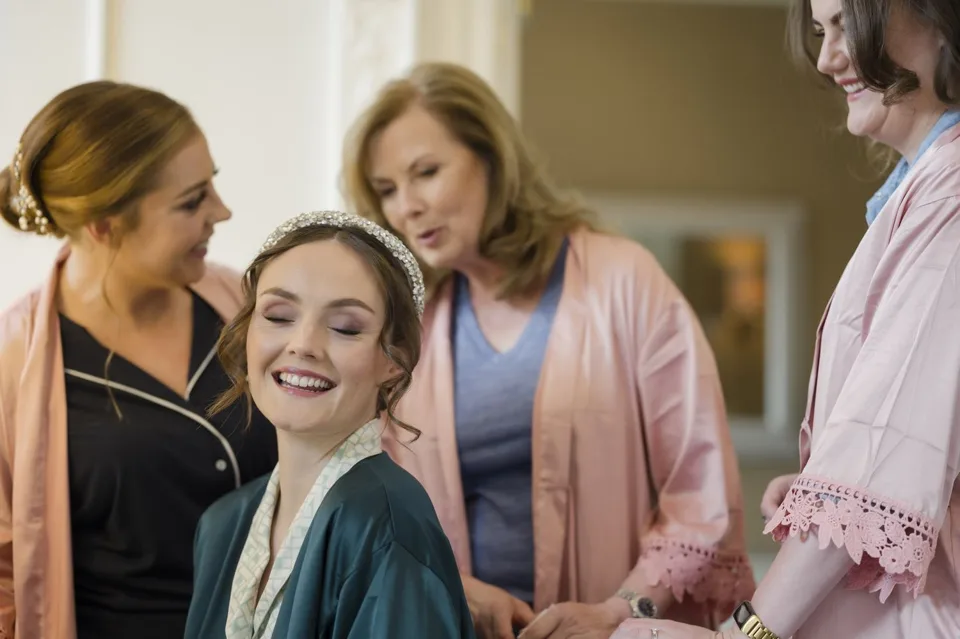 Carole laughing with the people helping her get ready.