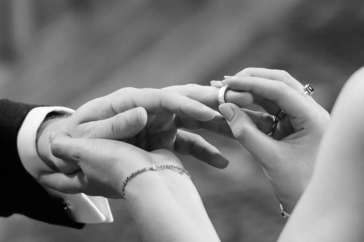 A close black-and-white view of the ring exchange