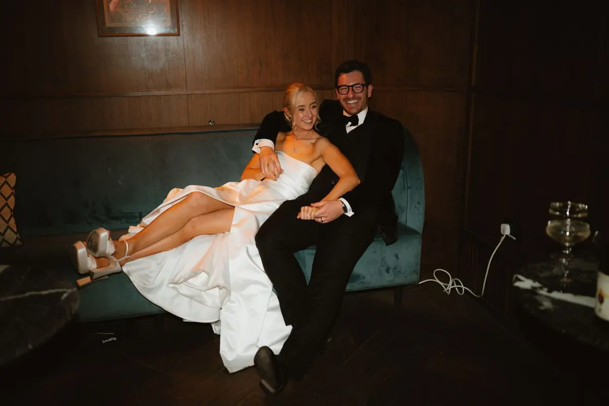 The groom holding the laughing bride in his arms