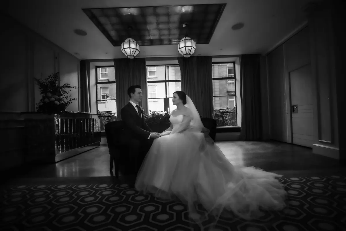 A black-and-white portrait of the couple in the hotel interior