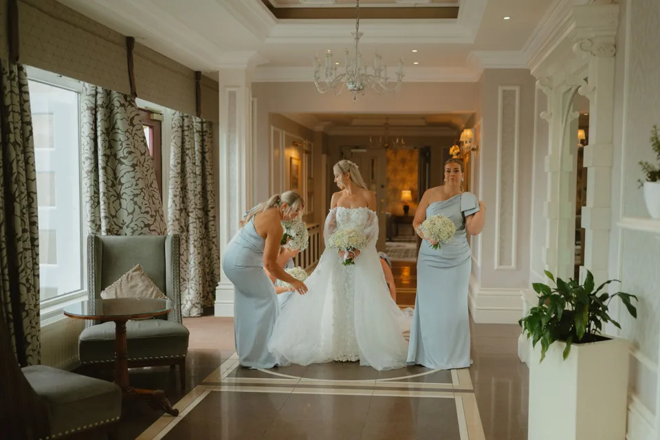 Bride in white gown with two bridesmaids in light blue dresses in Manor House Co. Fermanagh