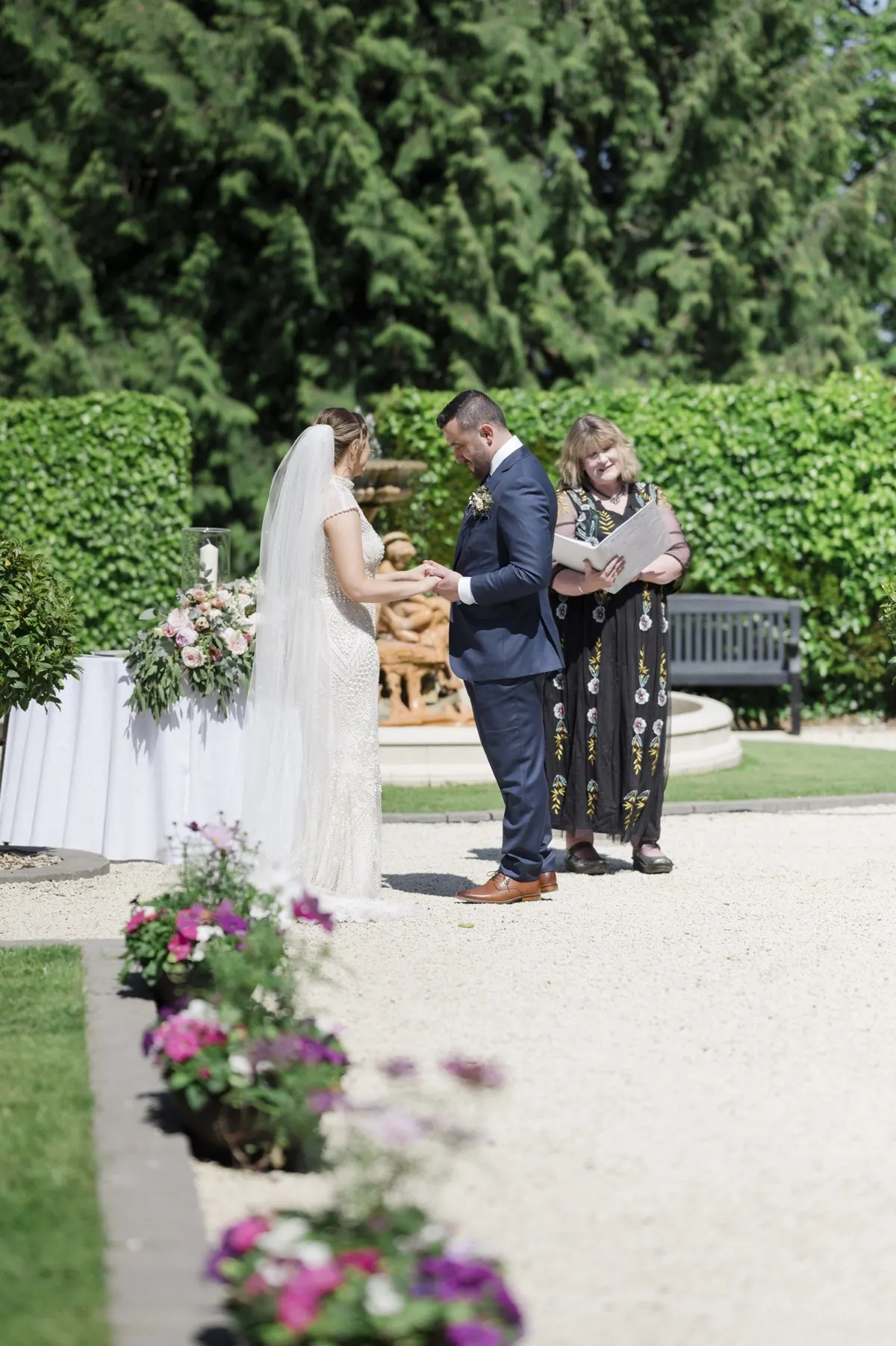 A wider view of the outdoor ceremony and garden setting