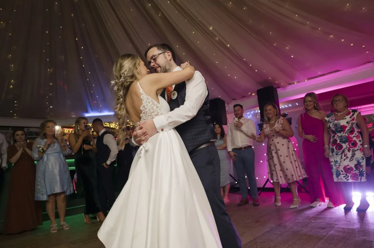 Charlie and Steven dancing with guests watching
