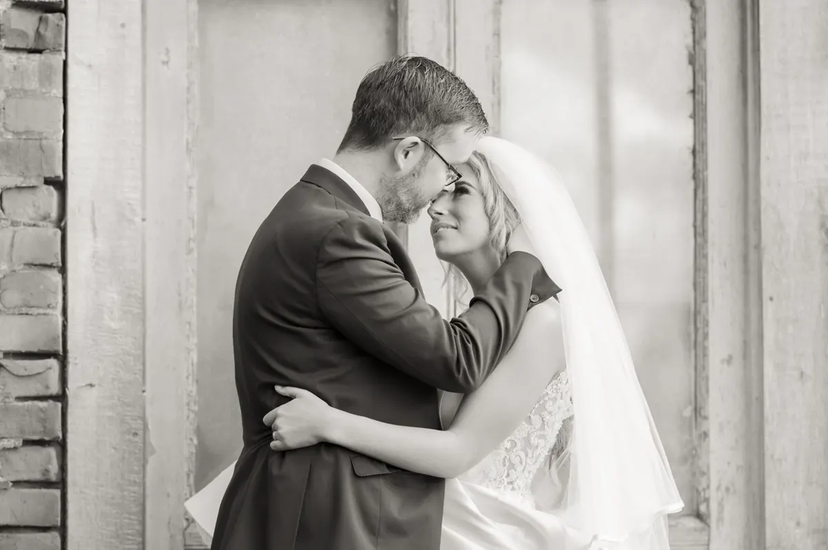 A close black-and-white portrait of the couple