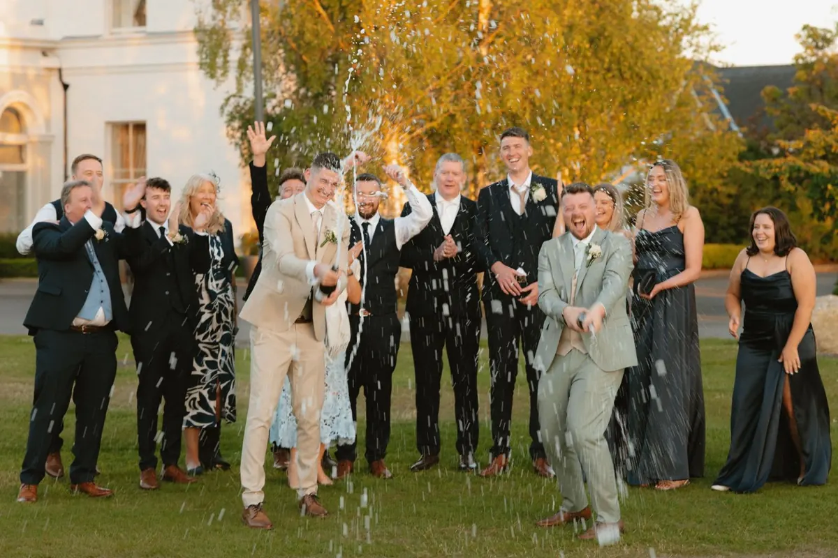 A group raising their glasses on the lawn