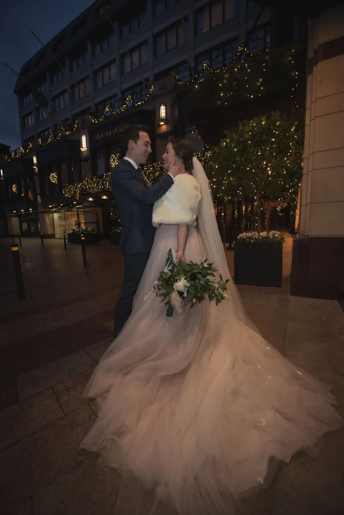 The couple at the entrance to The Westbury at night