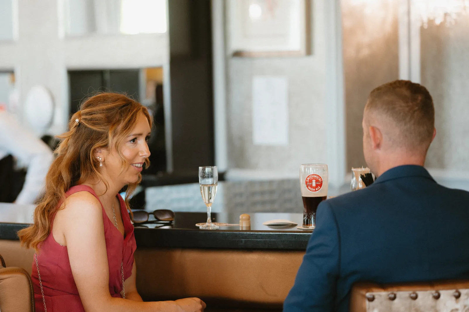 Guests talking at the bar