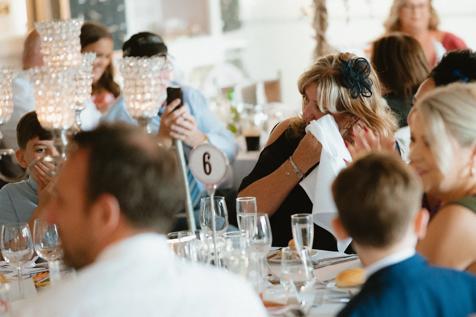 Guests seated among glassware and table decorations
