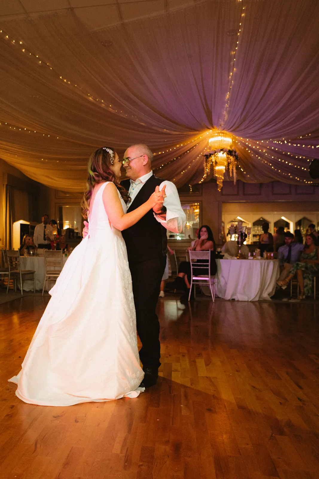 Alice and Darren dancing beneath draped fabric