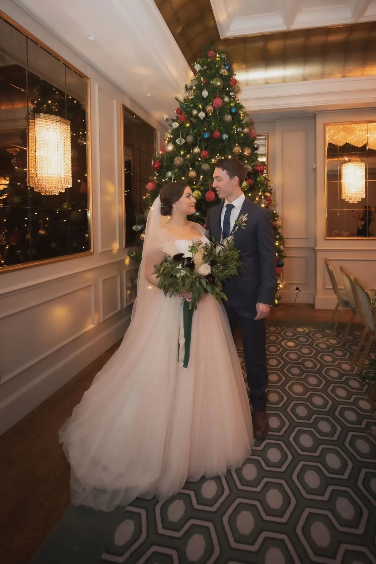 The couple together in a softly lit hotel corridor