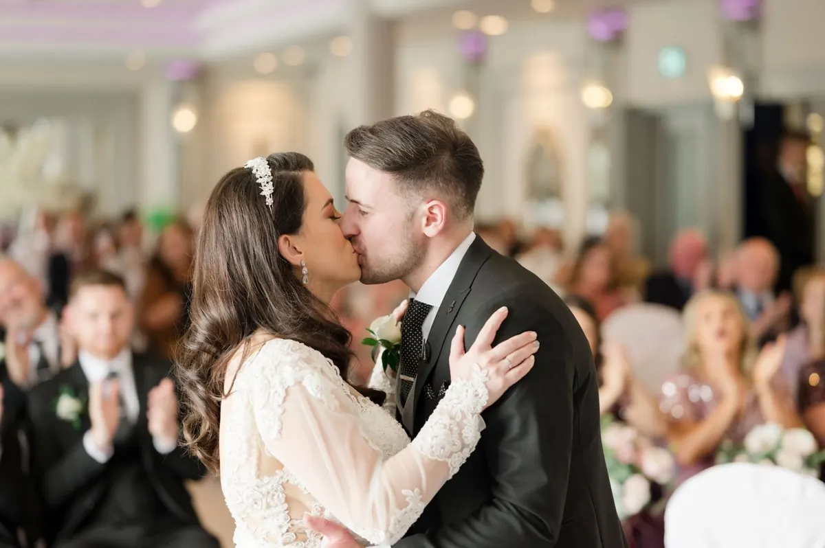 Michelle and Chris kissing during their ceremony.