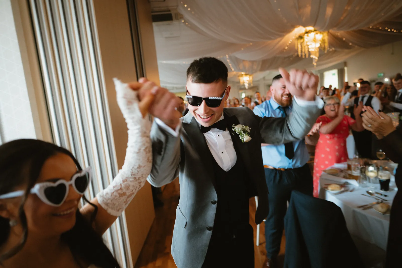 Thomas raises his arms at the reception