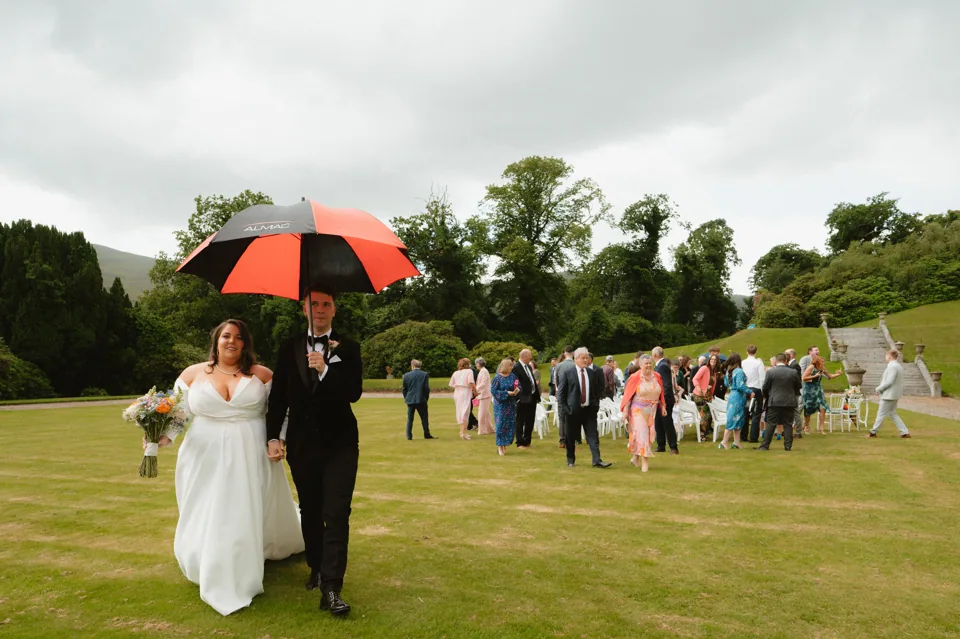 Brooke and David beneath colourful umbrellas