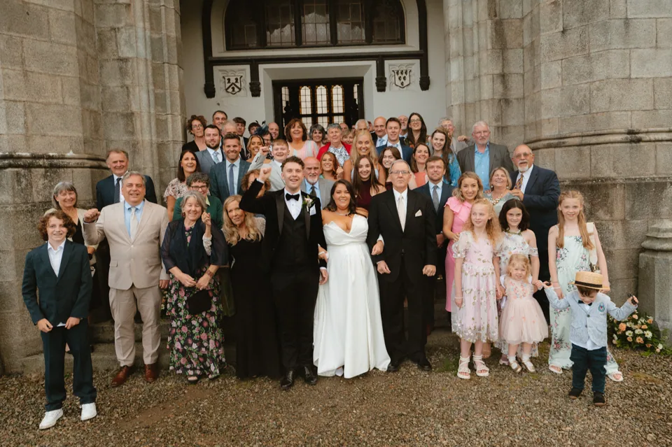 A wedding group at the castle entrance