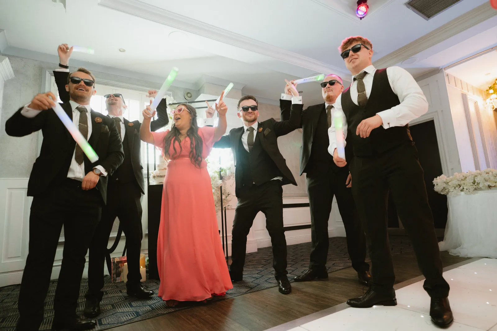 Guests raise their arms at the reception