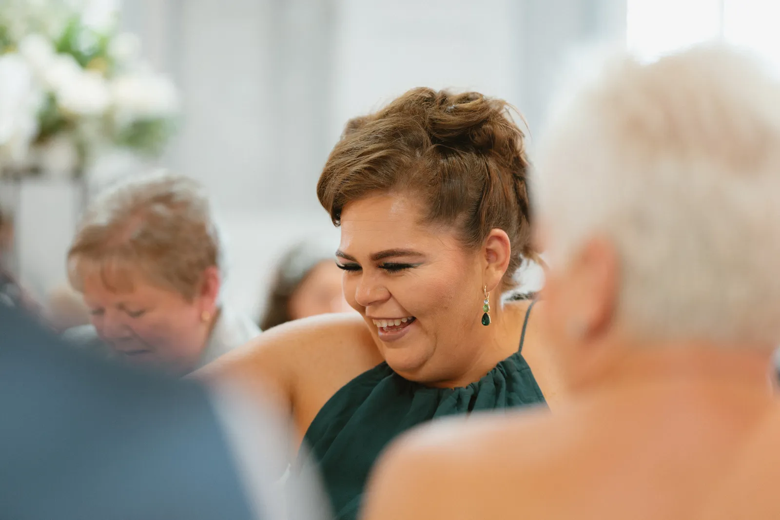 A guest laughs during the speeches