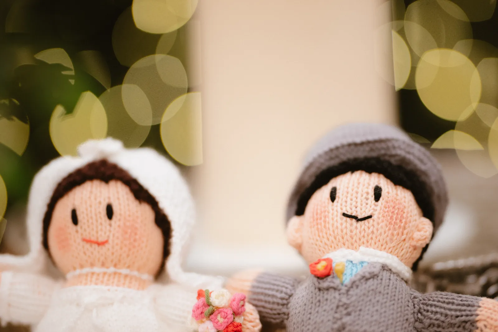 Two small knitted wedding figures