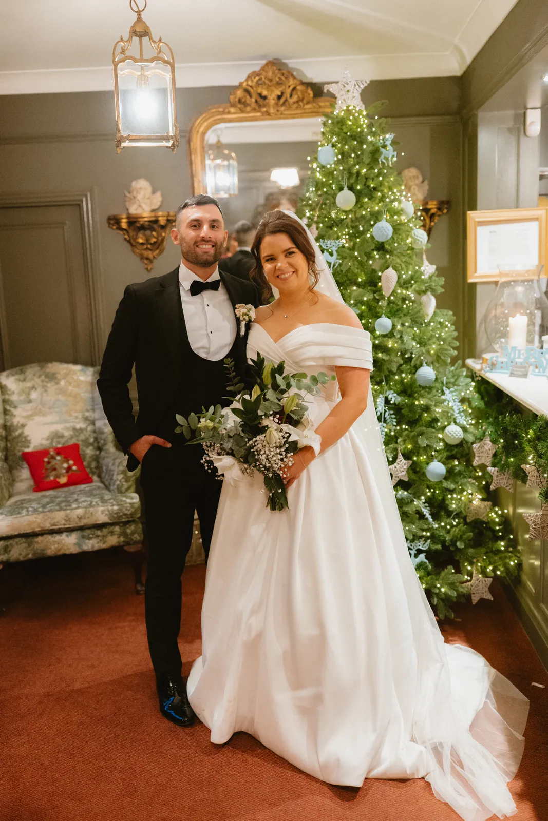 The couple beside a Christmas tree