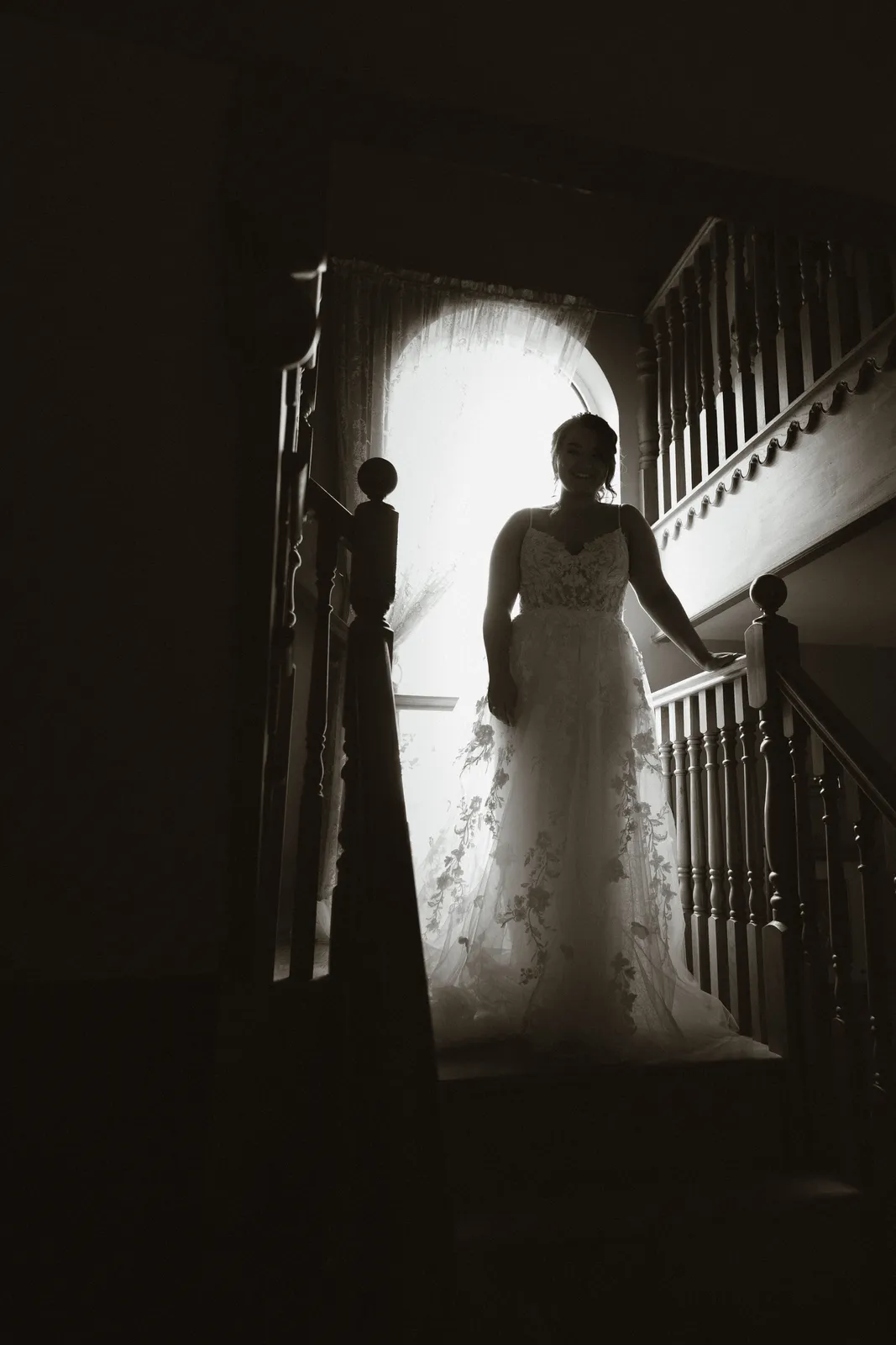 Claire silhouetted on the stairs