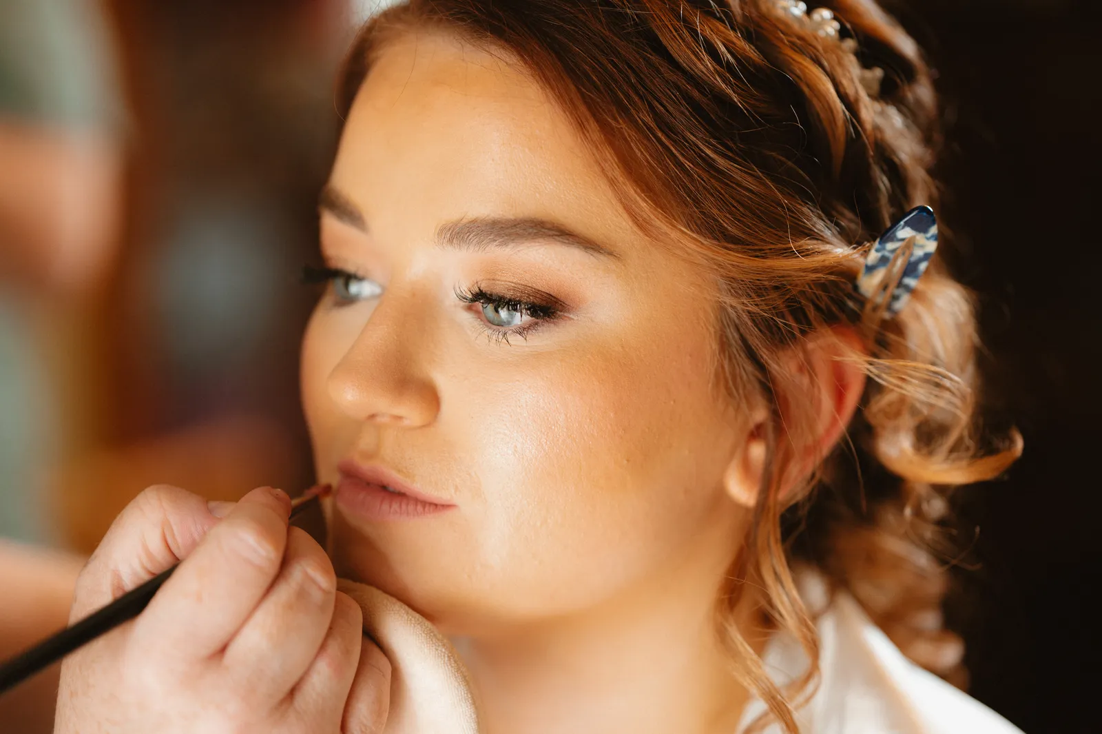Makeup finishing touches for Claire