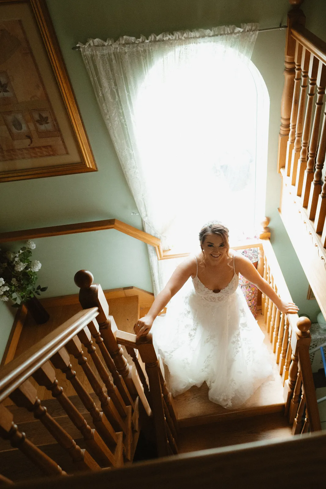 Claire holding her dress on the staircase