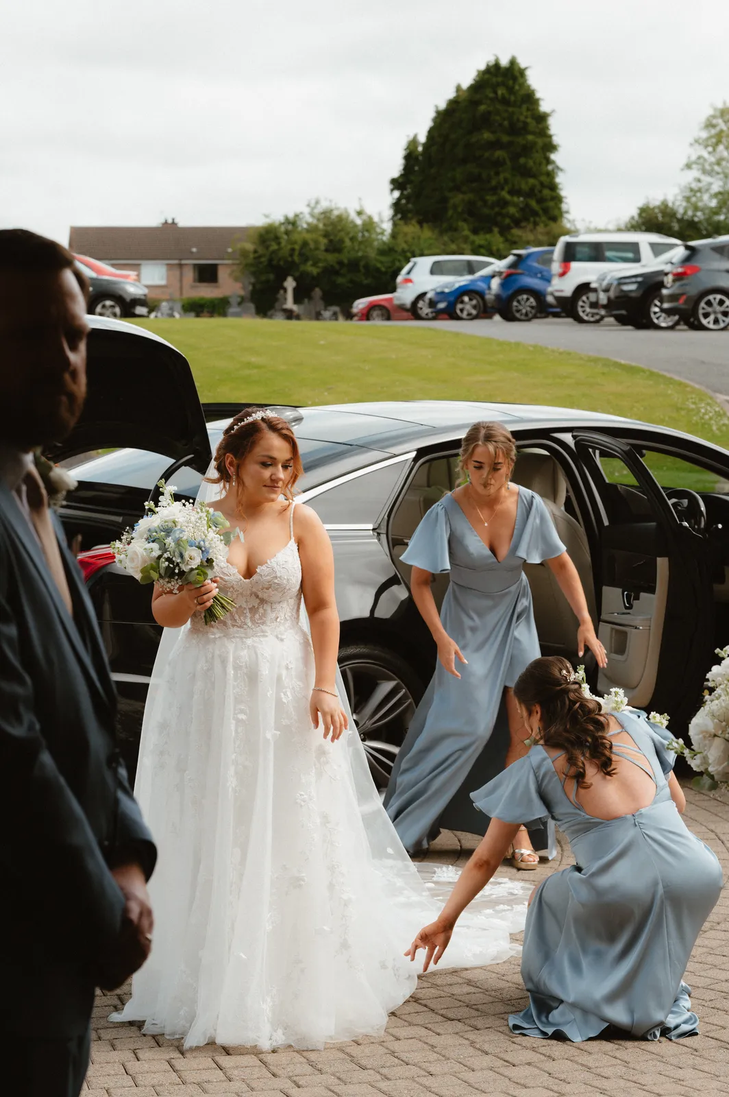 Guests help Claire from the car