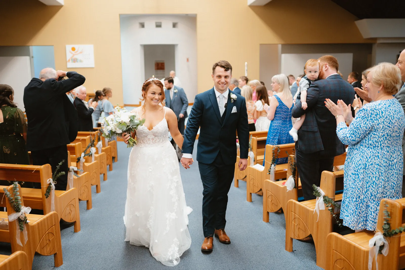 The couple walk down the aisle