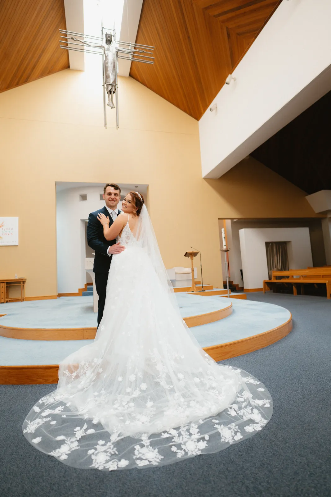 The couple standing inside the church