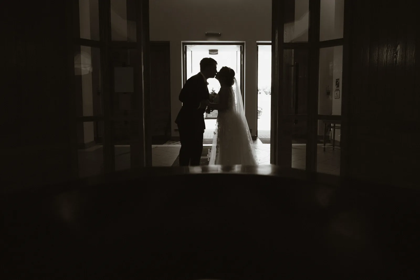 The couple silhouetted in a doorway